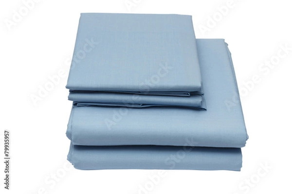 Fototapeta Folded bed linen on white isolated background