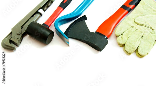 Fototapeta Many working tools - axe, glove and others on white background.