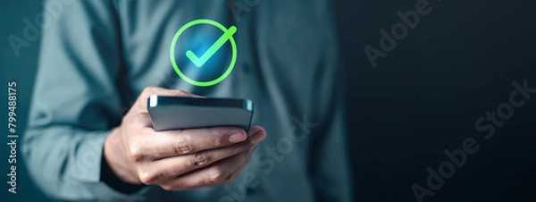 Fototapeta checkmark, confirm, accept, check, complete, marketing, tick, information, mark, checklist. A man is holding a smartphone with a check mark. Concept of approval or satisfaction.