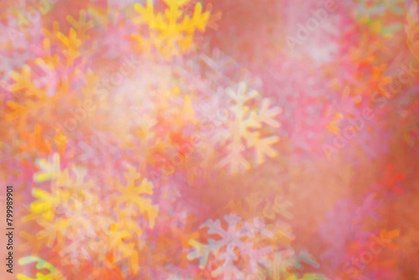 Fototapeta Defocused abstract figured bokeh background, glare from lights as snowflakes, blurred snowflake bokeh as winter holiday texture. Creative New Year aesthetic textured lighting pattern for festive