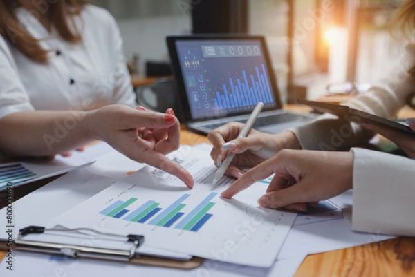 Obraz Technology and financial advisory services concept. Business teamwork and working on digital laptop computer with advisor showing plan of investment to clients at table office. Digital marketing.