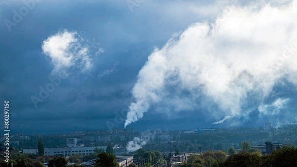 Fototapeta Smoke from a chimney against the backdrop of an industrial urban area, bad ecology concept