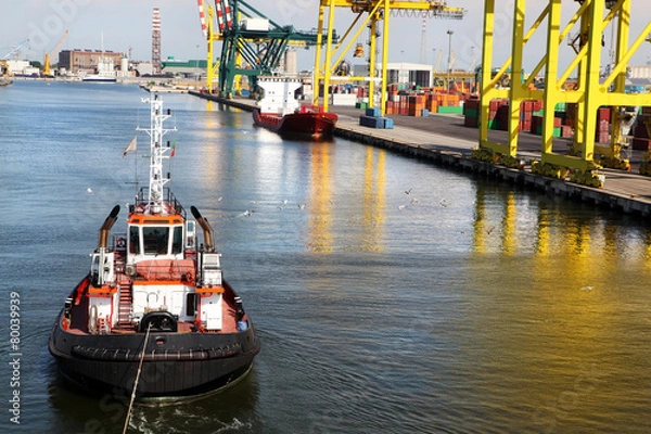Obraz Tugboat pulling container ship