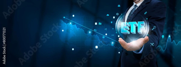 Fototapeta ETF: Businessman hand holding virtual ETF icon with Technological Icons. Investment Opportunities and Market Trends.