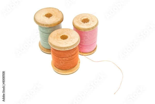 Fototapeta three wooden spools of thread