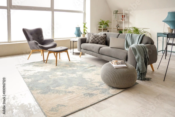Fototapeta Stylish interior of white living room with black sofa and armchair
