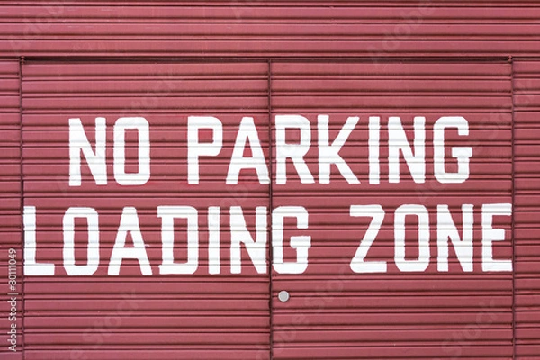 Obraz Word of No parking loading zone on metal red door