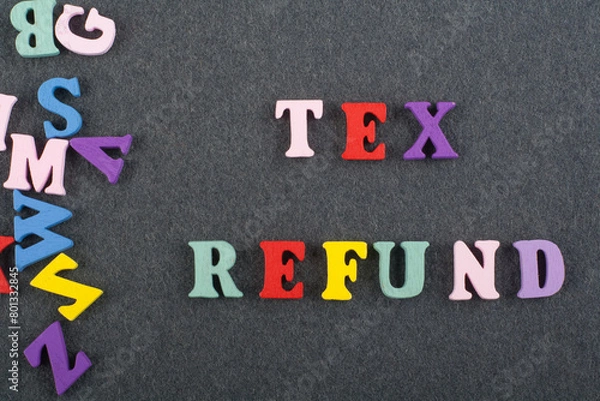Fototapeta TEX REFUND word on black board background composed from colorful abc alphabet block wooden letters, copy space for ad text. Learning english concept.