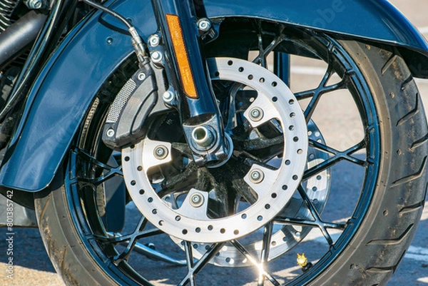 Fototapeta brake disc with the brake system of the front wheel of the chopper. front fork with side reflector. detailed view.