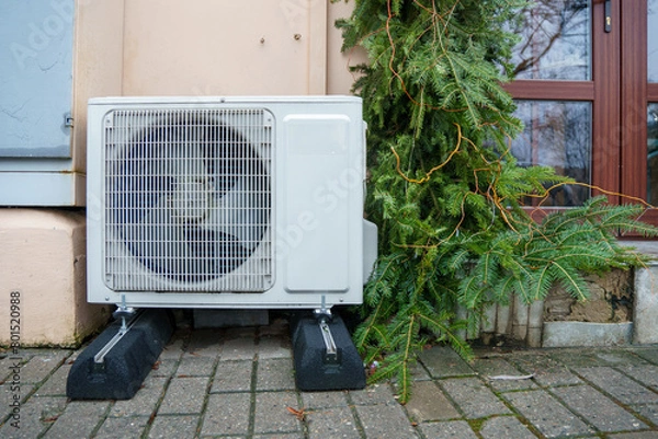 Fototapeta Outdoor air conditioning unit. A large modern air conditioner on the wall of an apartment building. Repair and maintenance of the air conditioning system