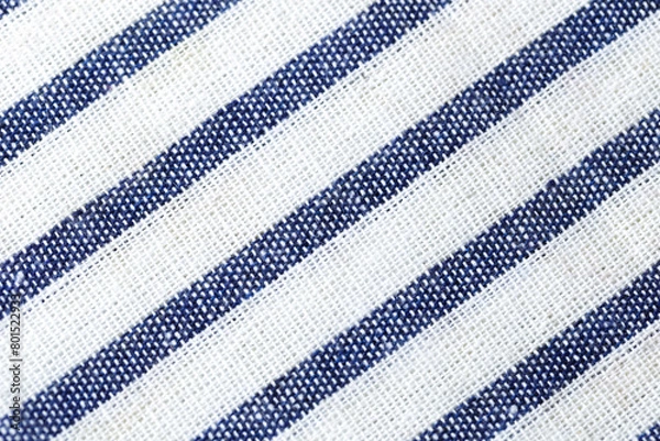 Fototapeta Texture of a blue and white striped fabric. The stripes are diagonal and the background is white