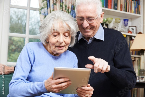 Fototapeta Senior Couple Using Digital Tablet At Home