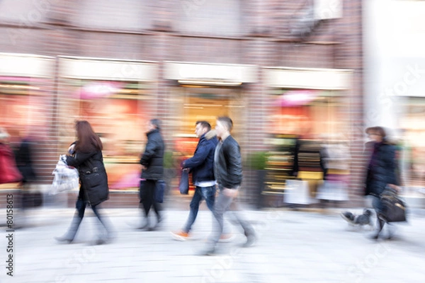 Fototapeta Shopper walking against shop window, zoom effect, motion blur