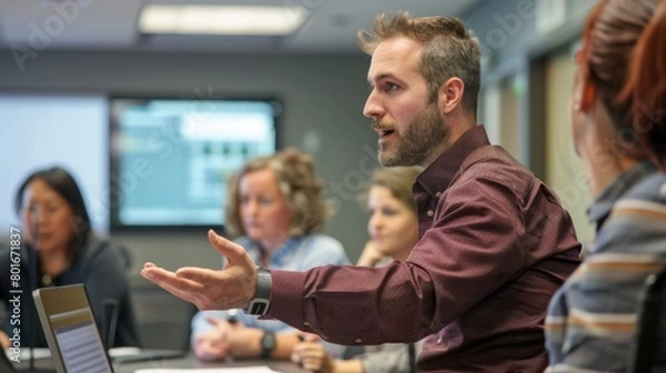Obraz A young professional facilitates an interactive training session in a corporate office, demonstrating effective communication and engagement techniques.