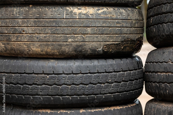 Fototapeta Old tires stacked in a heap, forming a textured pattern