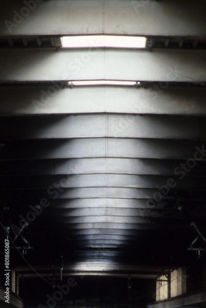 Fototapeta Vertical image of sky lights in roof space. natural sunlight white blurry pattern. black wall space. two small window embrasures with back lighting. Location Euston Railway Station London UK 2003
