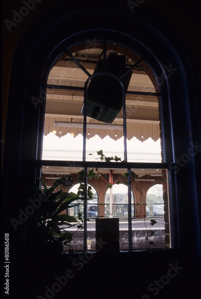 Fototapeta vertical image, view of outside from interior room aspect.  Exterior platform details. Location Woodbridge Railway station Suffolk UK 2003
