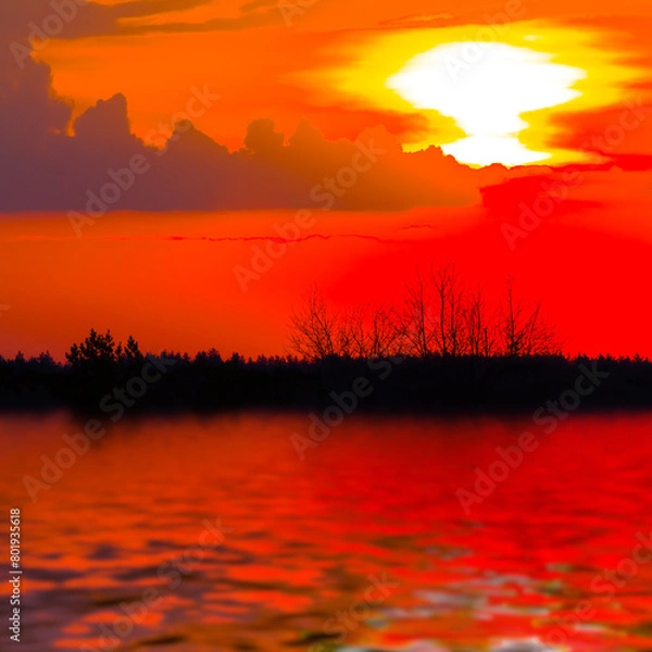 Fototapeta red dramatic sunset reflected in a calm lake