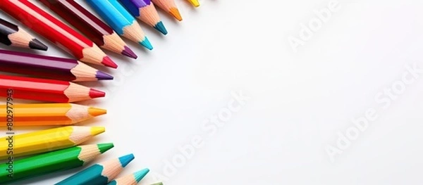 Fototapeta A copy space image showing colorful pencils placed in the center on a white background Ideal for kids to study and learn art as they go back to school