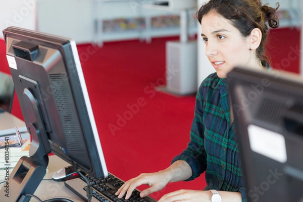 Obraz Studying and Working on a Computer at Library