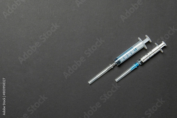 Fototapeta Top view of syringes in a row for medical injection on colorful background with copy space. Health and vaccination concept