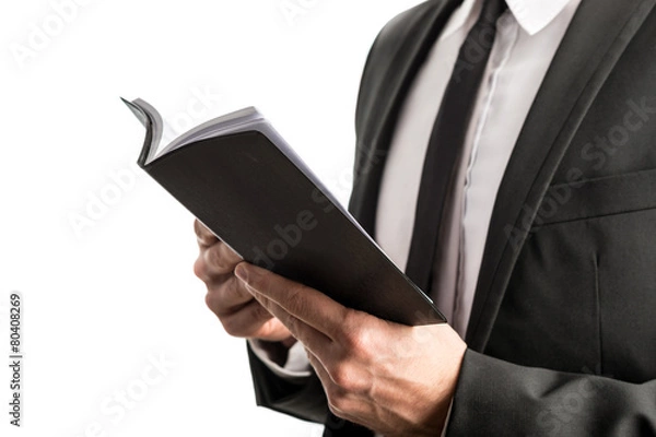 Fototapeta Businessman reading from a notebook