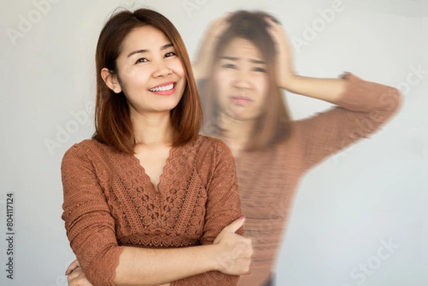 Obraz bipolar and smiling depression concept with Asian woman in difference mood , double personality with positive and negative emotional