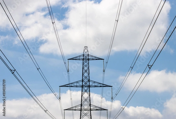 Fototapeta Photo of an electronic pylon on a blue sky day with a few clouds in the sky