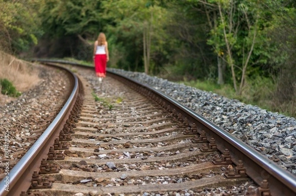 Fototapeta Girl walking on rails
