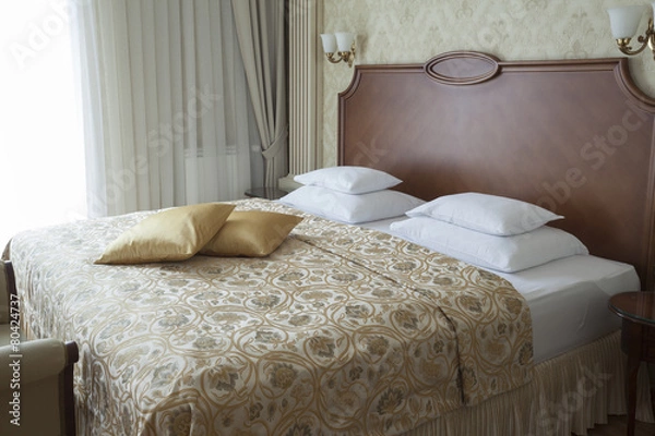 Fototapeta king size bed with pillows in luxury apartment