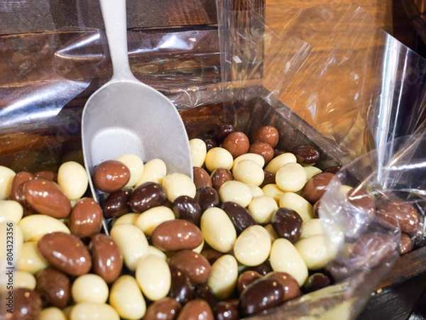 Fototapeta Chocolate Sweets and Candy Close up - Indulge in the Sweet Avalanche, A Tempting Mountain of Colourful Choc Confectionery Delights. Unhealthy diabetic and sugar addiction concept