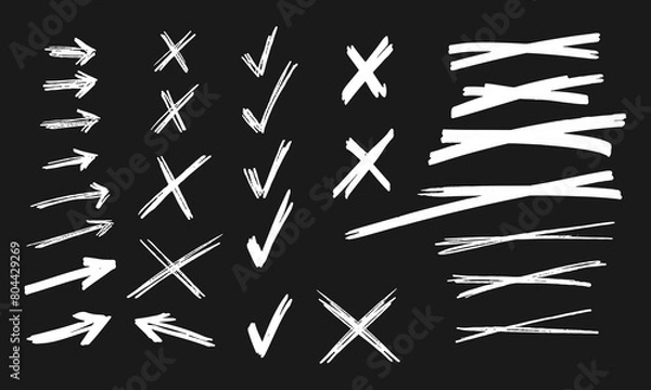 Fototapeta Twenty eight handwritten squiggles. White strikethroughs, crosses, arrows, V-shaped marks on a black background. Vector set