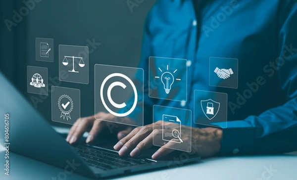 Fototapeta Copyright or patent concept. Professional working on a laptop with digital icons representing intellectual property and digital copyright law. Trademark license, copyleft, Rights symbol, Piracy crime,
