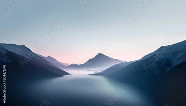 Obraz Mountain peaks bathed in golden light as the sun rises over the horizon