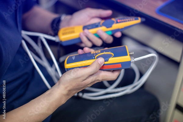 Fototapeta Network cable tester. Testing structured cabling using qualified cable performance tester. UTP cable with RJ45 jack checking with digital cable tools.