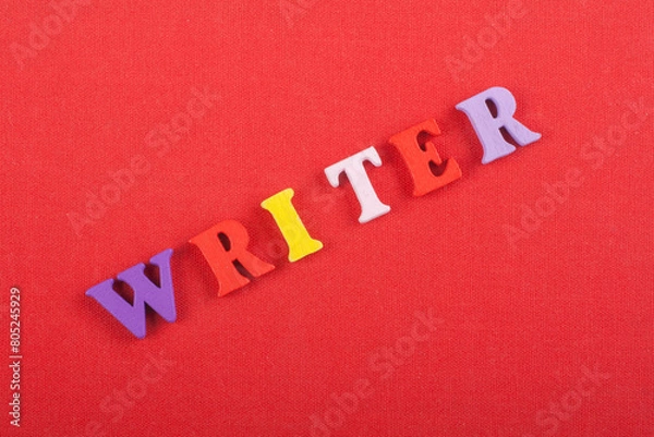 Fototapeta WRITER word on red background composed from colorful abc alphabet block wooden letters, copy space for ad text. Learning english concept.