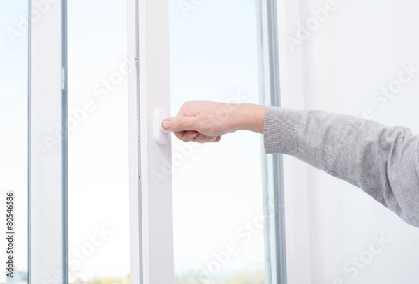 Fototapeta hand opens (closes) window