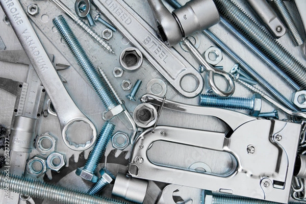 Fototapeta Many tools on the scratched metal background.