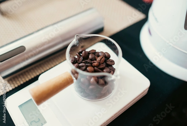 Fototapeta Coffee bean  on top of a digital coffee scale preparing for coffee brewing