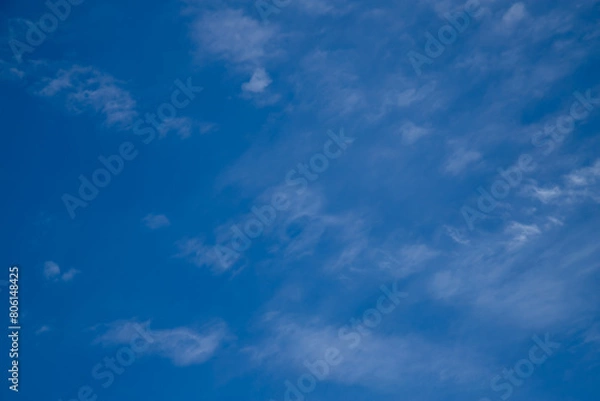 Fototapeta Blue sky with a few clouds background.