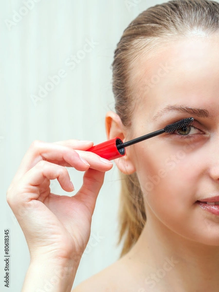 Obraz Woman applying mascara on eyelashes