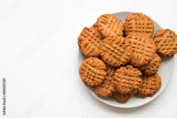 Obraz Stack of freshly baked peanut butter cookies on a light plate. White background. Copy space, place for your text.