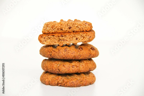 Obraz Stack of freshly baked peanut butter cookies. The top cookie is broken in half to see the texture of cookies. White background.