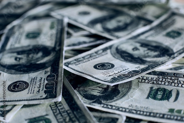 Fototapeta A pile of one hundred US banknotes with president portraits. Cash of hundred dollar bills, dollar background image with high resolution