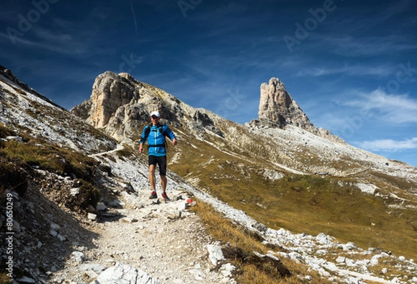 Obraz Man running downhill in Dolomites