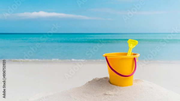 Fototapeta plastic beach bucket against the beach with waves