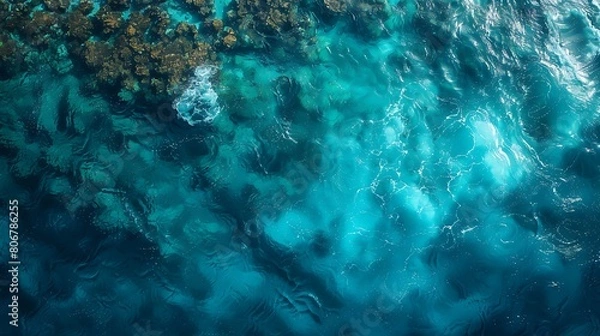 Fototapeta An abstract aerial view of coral reefs under tropical water, with aqua hues blending softly to create a peaceful underwater mosaic.