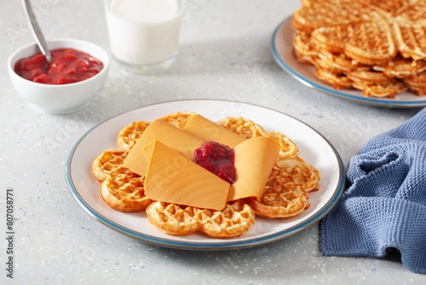 Fototapeta waffles with Norwegian brunost traditional brown cheese and raspberry jam