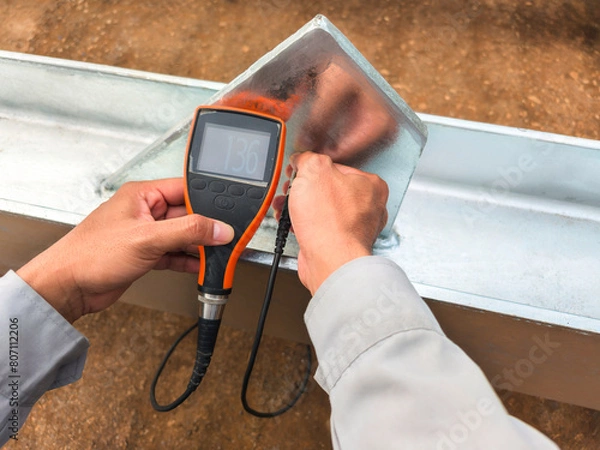 Fototapeta Measure the Coating Thickness Galvanized with a Coating Thickness Gauge by Specification of Project for Steel Structure Work at Industrial Factories.