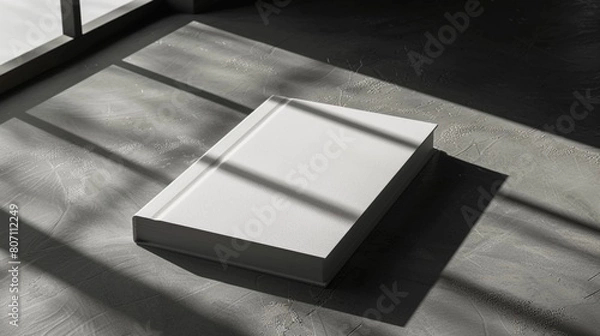 Obraz book cover on table with shadows not write anying on it,copyspace